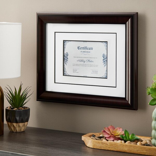 certificate wall frame above wood table